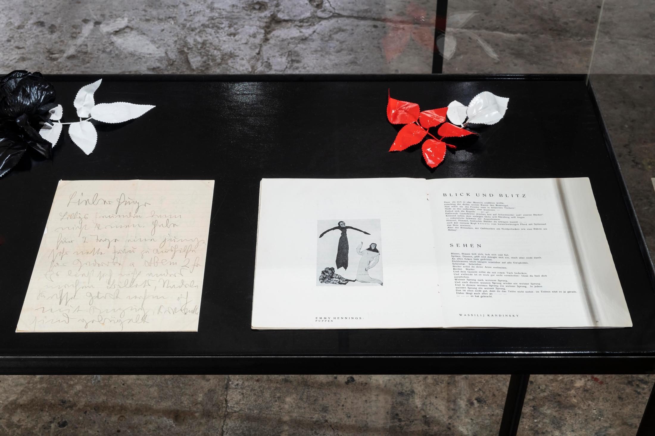 Exhibition View Emmy Hennings / Sitara Abuzar Ghaznawi Joint Exhibition (view on Sitara Abuzar Ghaznawi, Showcase (Deep Black), 2020; Emmy Hennings, Brief an Hugo Ball, 1916; Cabaret Voltaire Heft (picture with puppets by Hennings on page 20), 1916) at Cabaret Voltaire, Zurich, 2020 / Photo: Gunnar Meier / Courtesy Sitara Abuzar Ghaznawi: the artist; Courtesy Emmy Hennings: Schweizerisches Literaturarchiv and Cabaret Voltaire