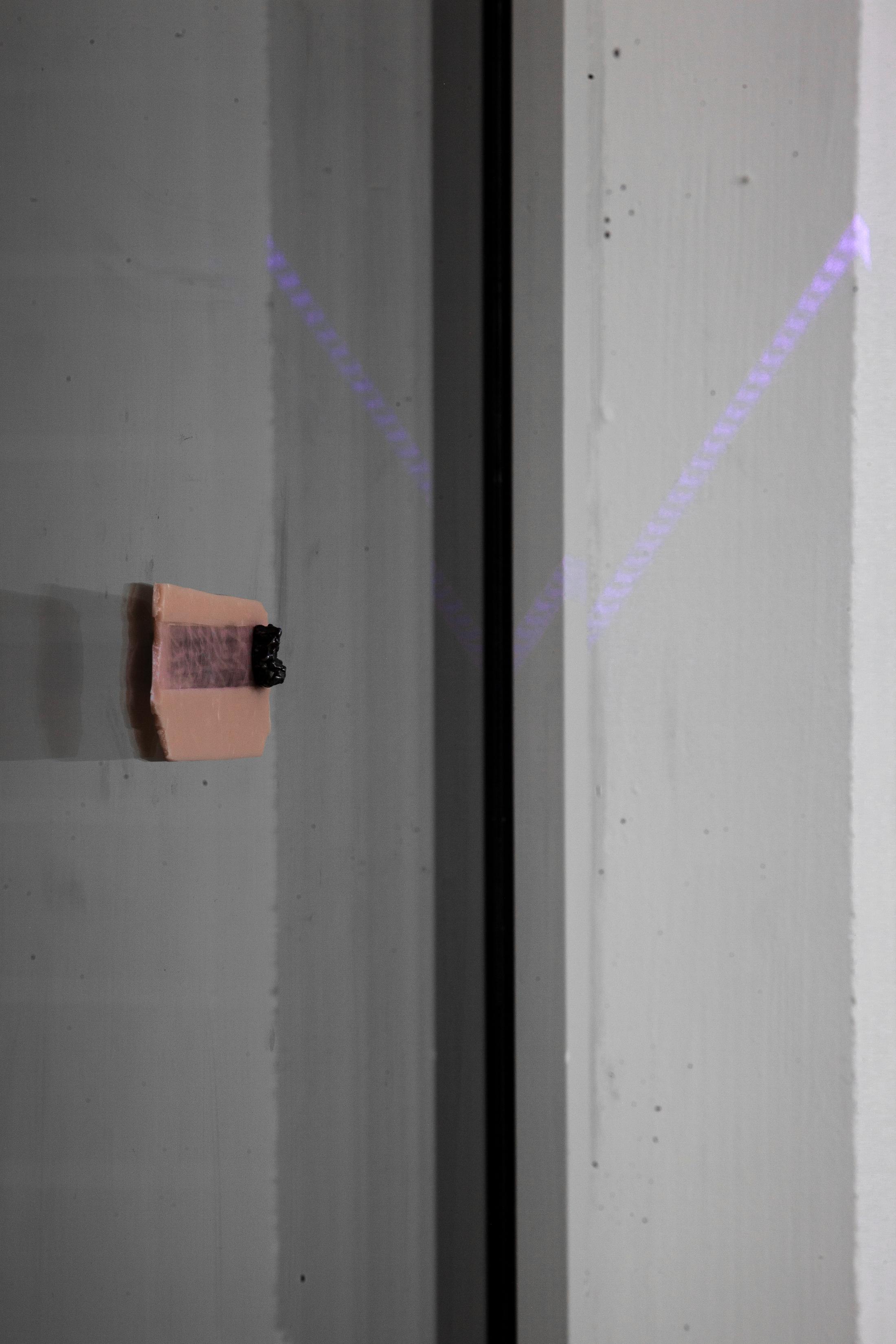 Exhibition View Hunter Longe Solo Show «Summoner; view on Hunter Longe, Death, 2023, Meteorite fragment, sculpy, magnet, 405 nm laser» at Espace 3353, Carouge, 2023 / Photo: Anastasia Mityukova / Courtesy: the artist and Espace 3353