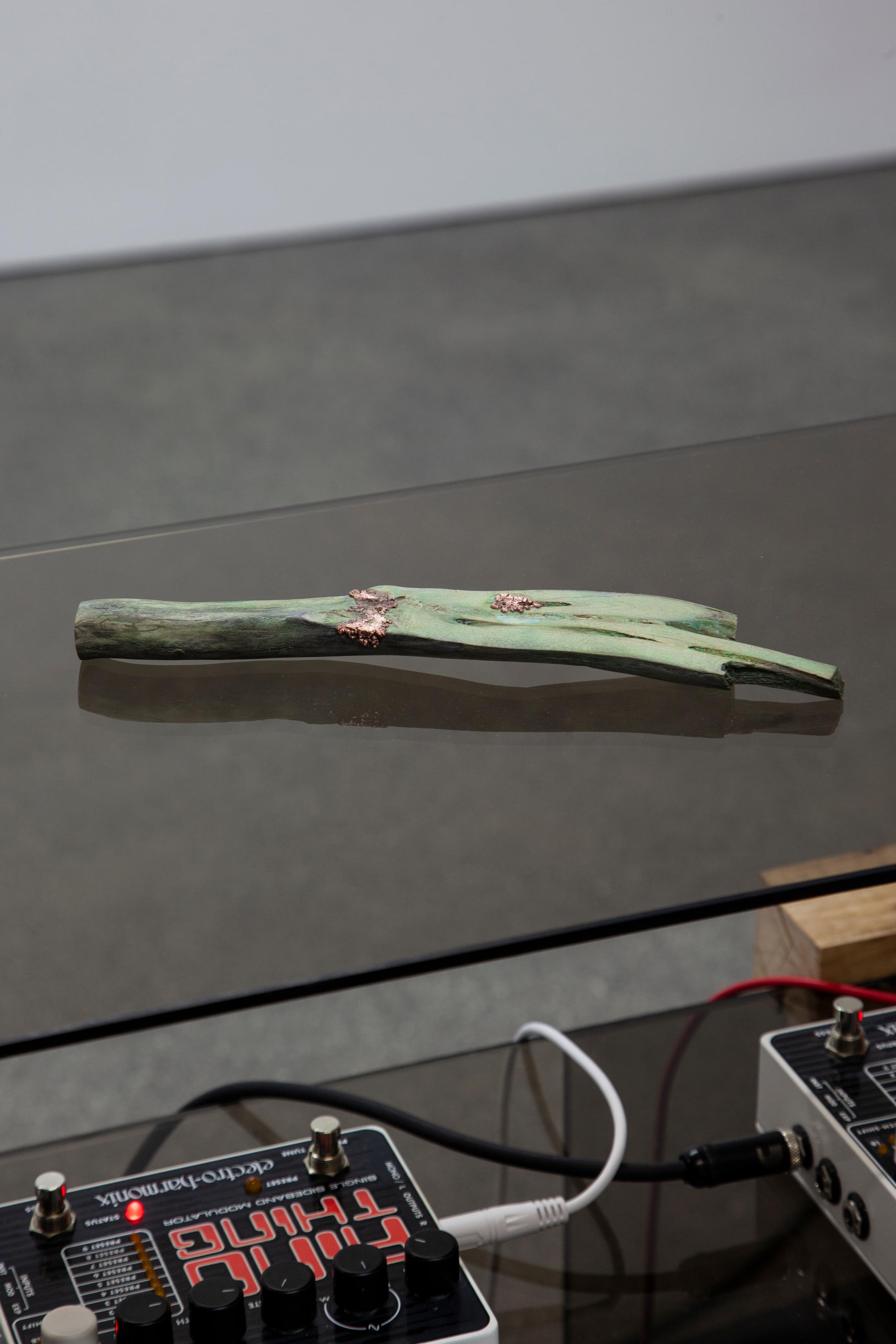 Exhibition View Hunter Longe Solo Show «Summoner; view on Hunter Longe, Summoner (ΧΘΟΥΜΙΛΟΝ), 2023, Glass, oak, driftwood, copper, copper sulfate, photovoltaicx cells, contact microphone, ring modulators, pitch shifter, audio cables, PA» at Espace 3353, Carouge, 2023 / Photo: Anastasia Mityukova / Courtesy: the artist and Espace 3353