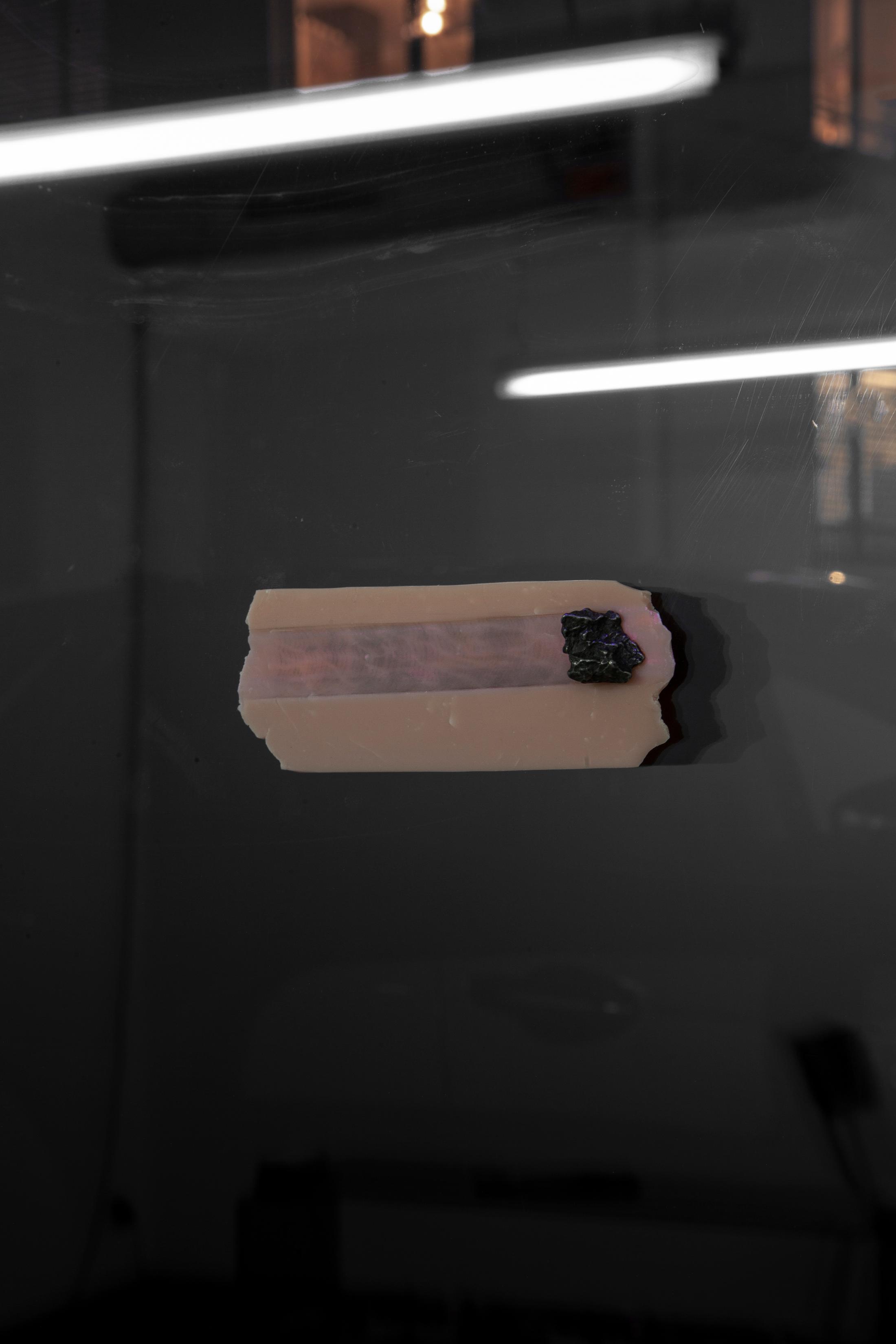 Exhibition View Hunter Longe Solo Show «Summoner; view on Hunter Longe, Death, 2023, Meteorite fragment, sculpy, magnet, 405 nm laser» at Espace 3353, Carouge, 2023 / Photo: Anastasia Mityukova / Courtesy: the artist and Espace 3353