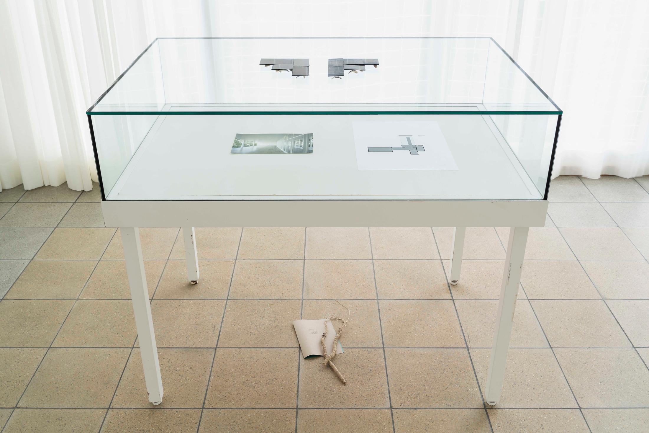 Exhibition View Group Show «Im Volksgarten; view on Richard Frater, Einladungsdilemma, 2020, (detail); On and under the vitrine: Richard Frater, For Rewi Thompson, 2020, Collodion wet plate ambrotype, two glass assemblages, modified Purimu cockle shells, paper, limb, cord, dimensions variable» at Kunsthaus Glarus, Glarus, 2020 / Photo: Gunnar Meier / Courtesy: the artist