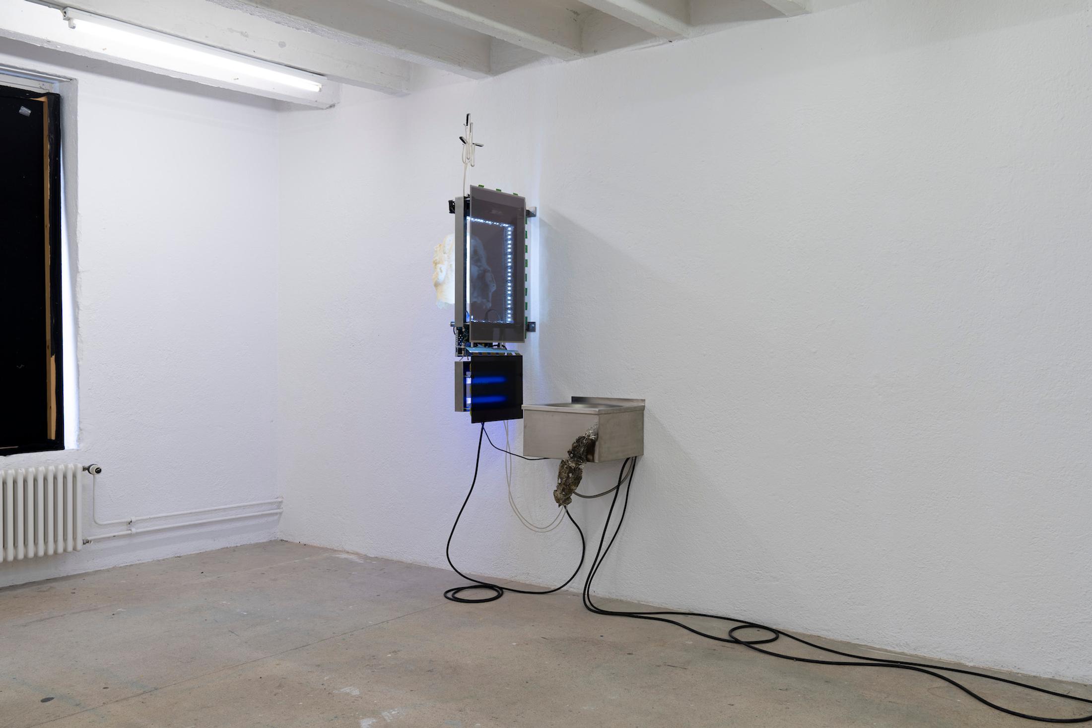 Exhibition View Group Show «Issue de secours; view on Chloé Delarue, TAFAA - FERTILITY DEVICE (NUDGE FOR THE SCAPEGOAT), 2021, Stainless steel, Neon, Polyurethan foam, Motor, Latex, Cigarettes, LCD screen, Led, Video» at Binz39, Zürich, 2021 / Photo: Claude Barrault / Courtesy: the artists and Binz39