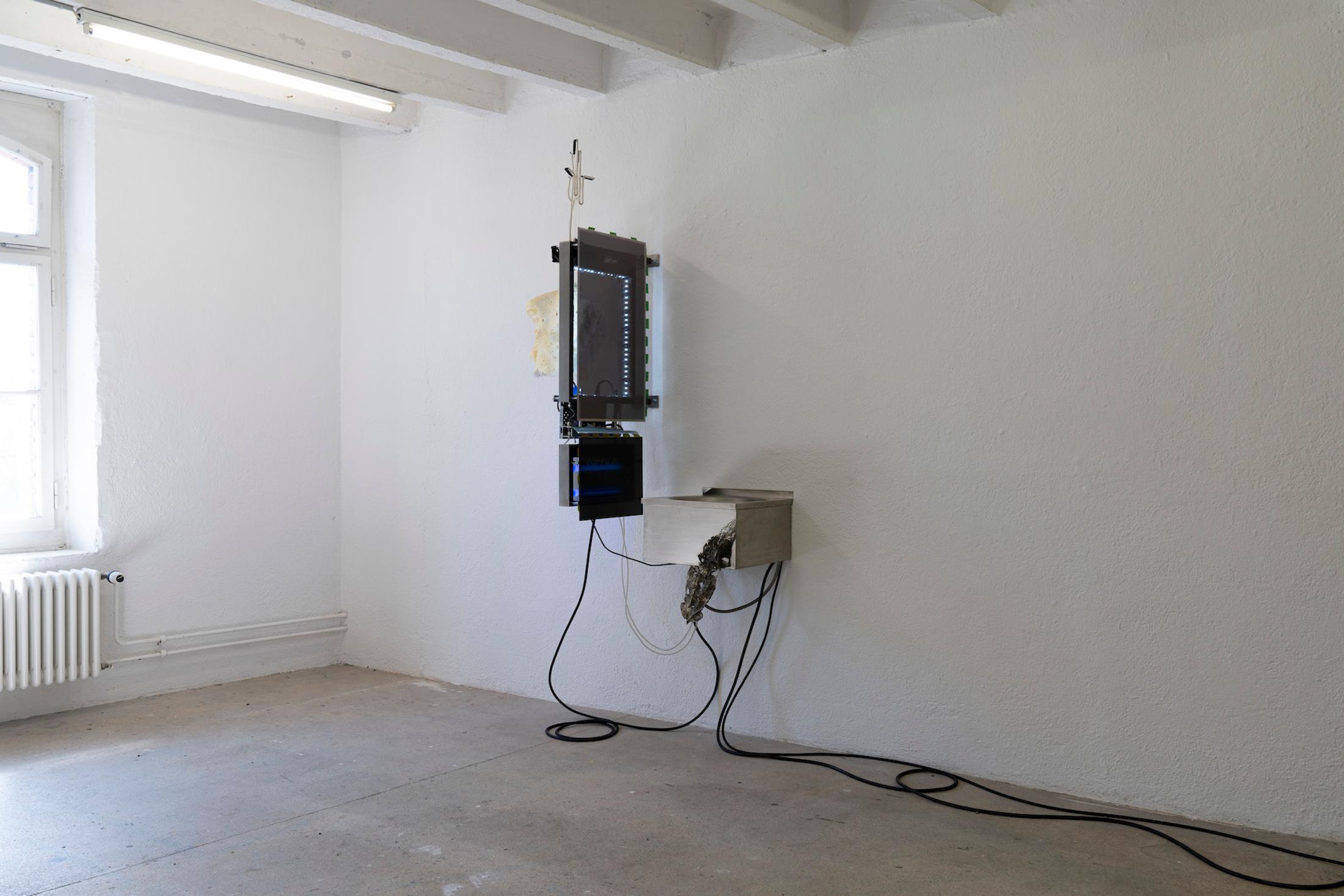 Exhibition View Group Show «Issue de secours; view on Chloé Delarue, TAFAA - FERTILITY DEVICE (NUDGE FOR THE SCAPEGOAT), 2021, Stainless steel, Neon, Polyurethan foam, Motor, Latex, Cigarettes, LCD screen, Led, Video» at Binz39, Zürich, 2021 / Photo: Claude Barrault / Courtesy: the artists and Binz39