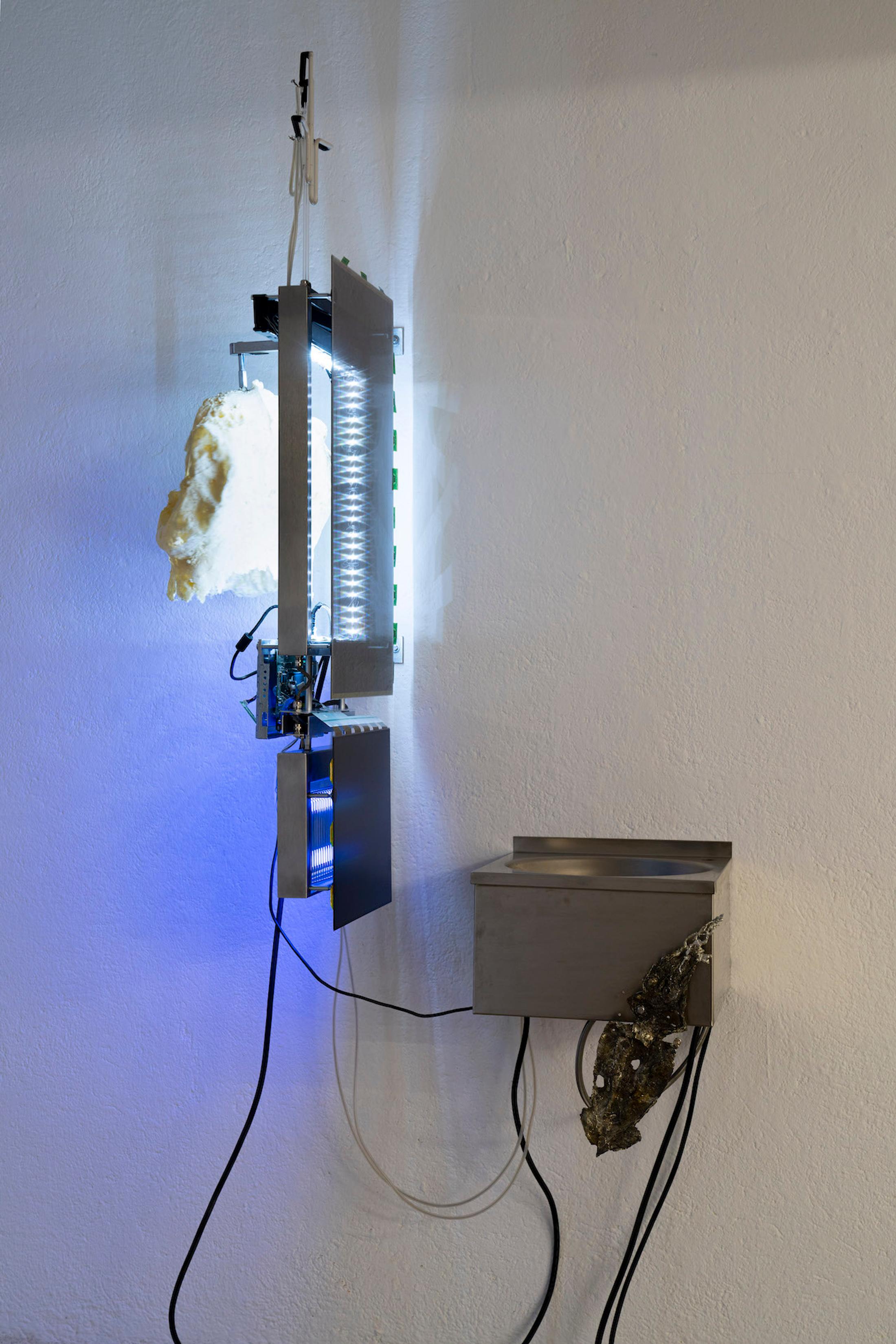 Exhibition View Group Show «Issue de secours; view on Chloé Delarue, TAFAA - FERTILITY DEVICE (NUDGE FOR THE SCAPEGOAT), 2021, Stainless steel, Neon, Polyurethan foam, Motor, Latex, Cigarettes, LCD screen, Led, Video» at Binz39, Zürich, 2021 / Photo: Claude Barrault / Courtesy: the artists and Binz39