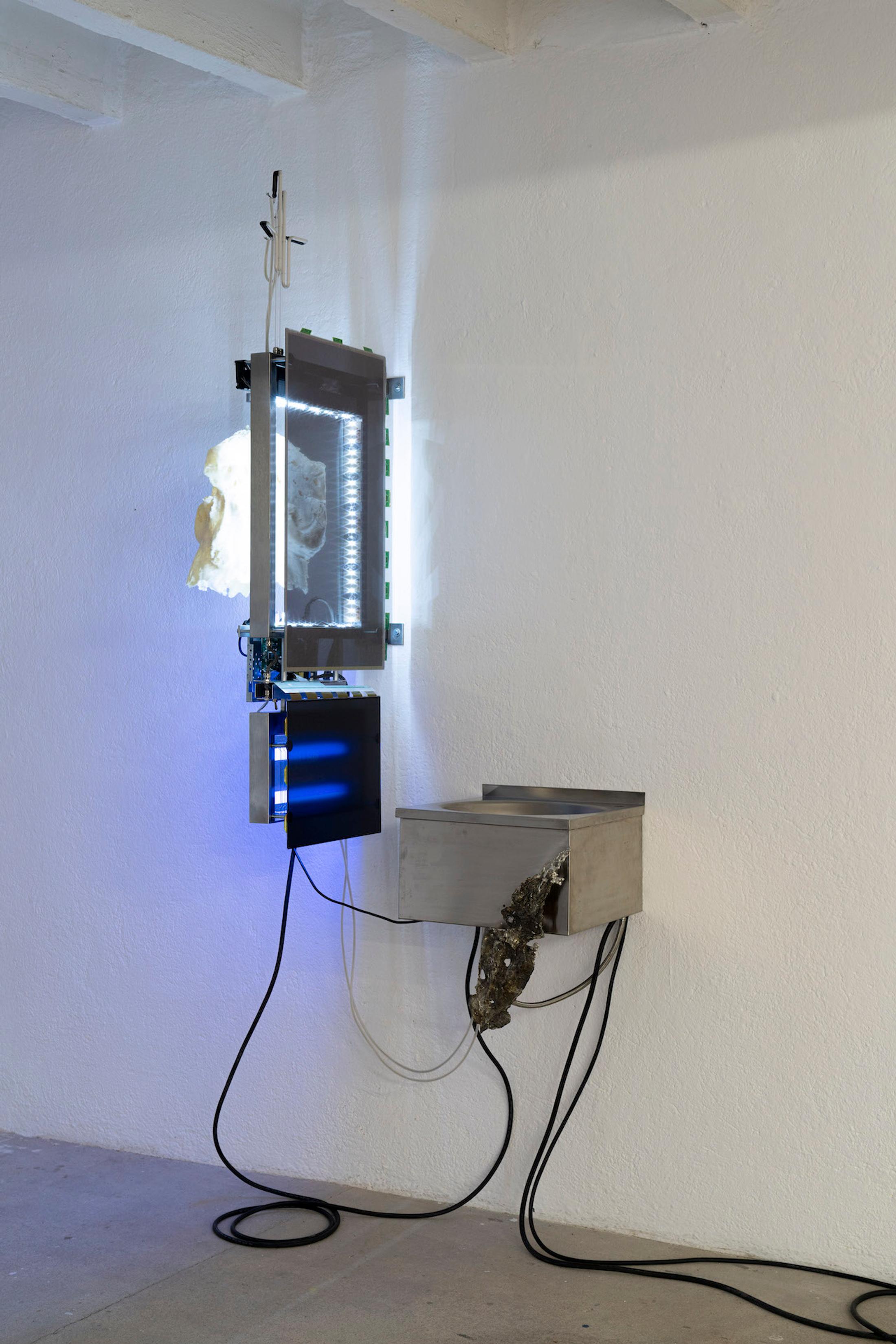 Exhibition View Group Show «Issue de secours; view on Chloé Delarue, TAFAA - FERTILITY DEVICE (NUDGE FOR THE SCAPEGOAT), 2021, Stainless steel, Neon, Polyurethan foam, Motor, Latex, Cigarettes, LCD screen, Led, Video» at Binz39, Zürich, 2021 / Photo: Claude Barrault / Courtesy: the artists and Binz39