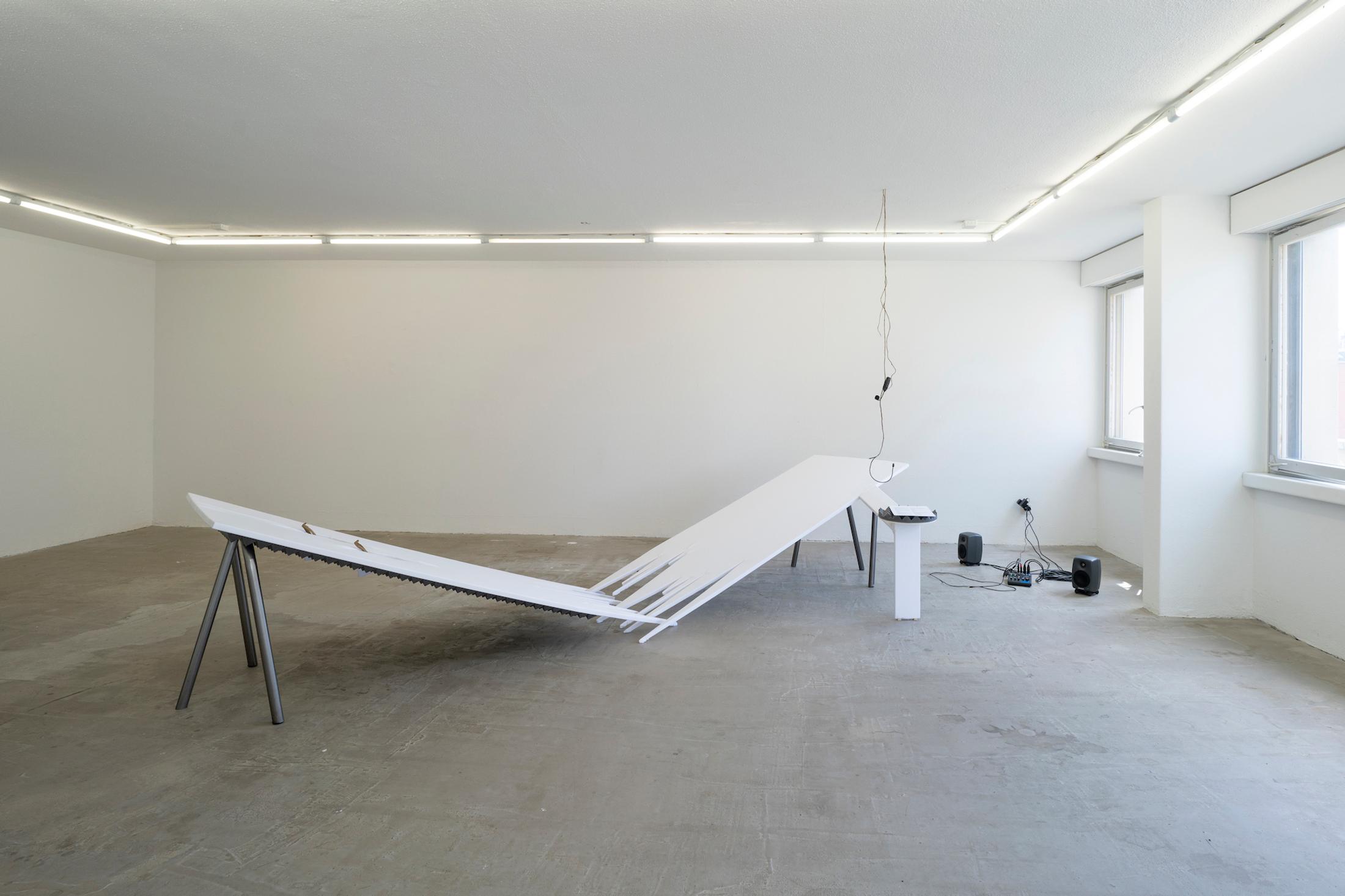 Exhibition View Mara Wohnhaas Solo Show «The fly on a speaker's nose; view on Mara Wohnhaas, The fly on a speaker's nose, 2023, Wooden board, fabric, acoustic, foam, shows, sand, root, headset microphone, text on paper, steel, nails, staples, 400 x 160 x 80 cm» at Hamlet, Zurich, 2023 / Photo: Claude Barrault / Courtesy: the artist and Hamlet