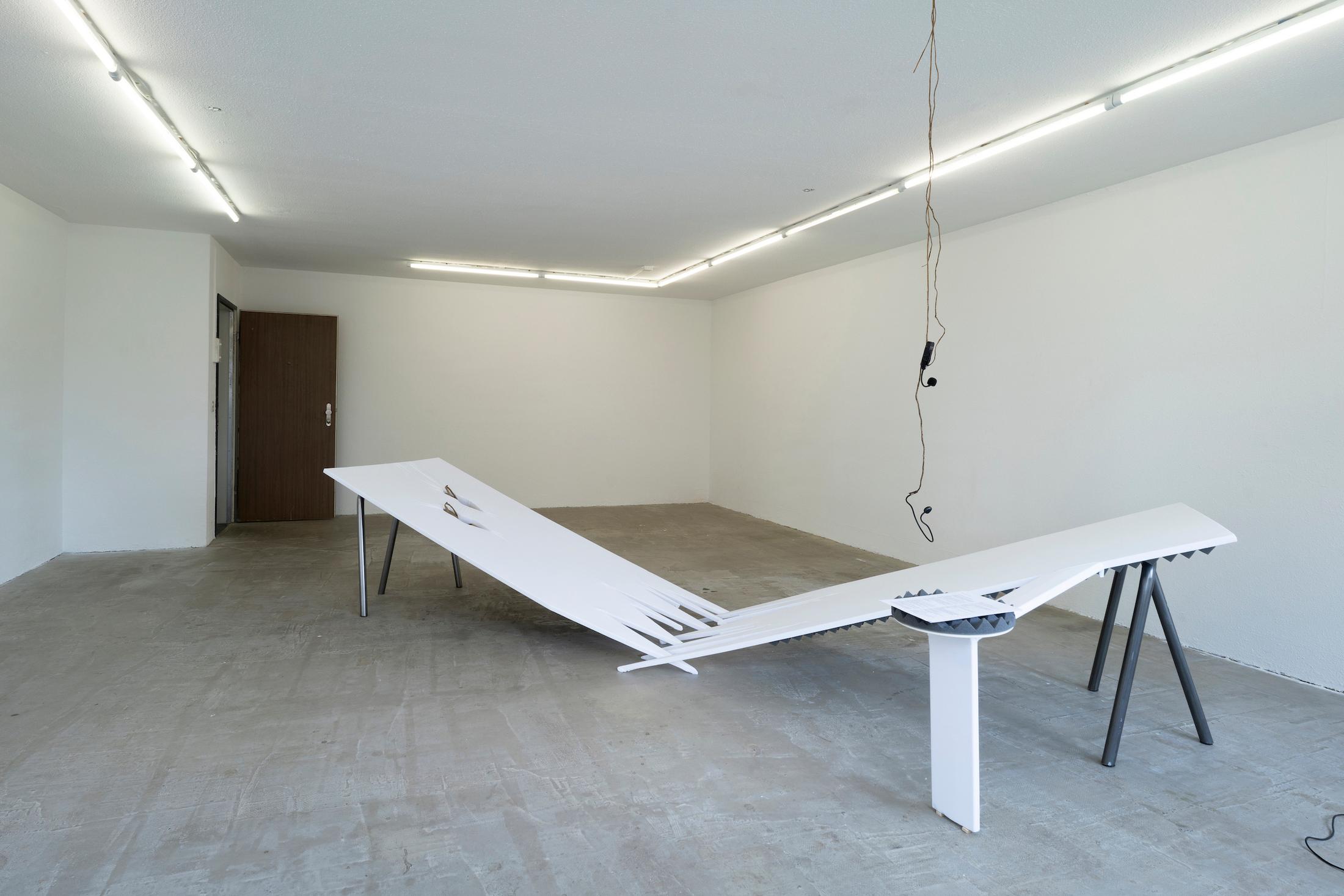 Exhibition View Mara Wohnhaas Solo Show «The fly on a speaker's nose; view on Mara Wohnhaas, The fly on a speaker's nose, 2023, Wooden board, fabric, acoustic, foam, shows, sand, root, headset microphone, text on paper, steel, nails, staples, 400 x 160 x 80 cm» at Hamlet, Zurich, 2023 / Photo: Claude Barrault / Courtesy: the artist and Hamlet