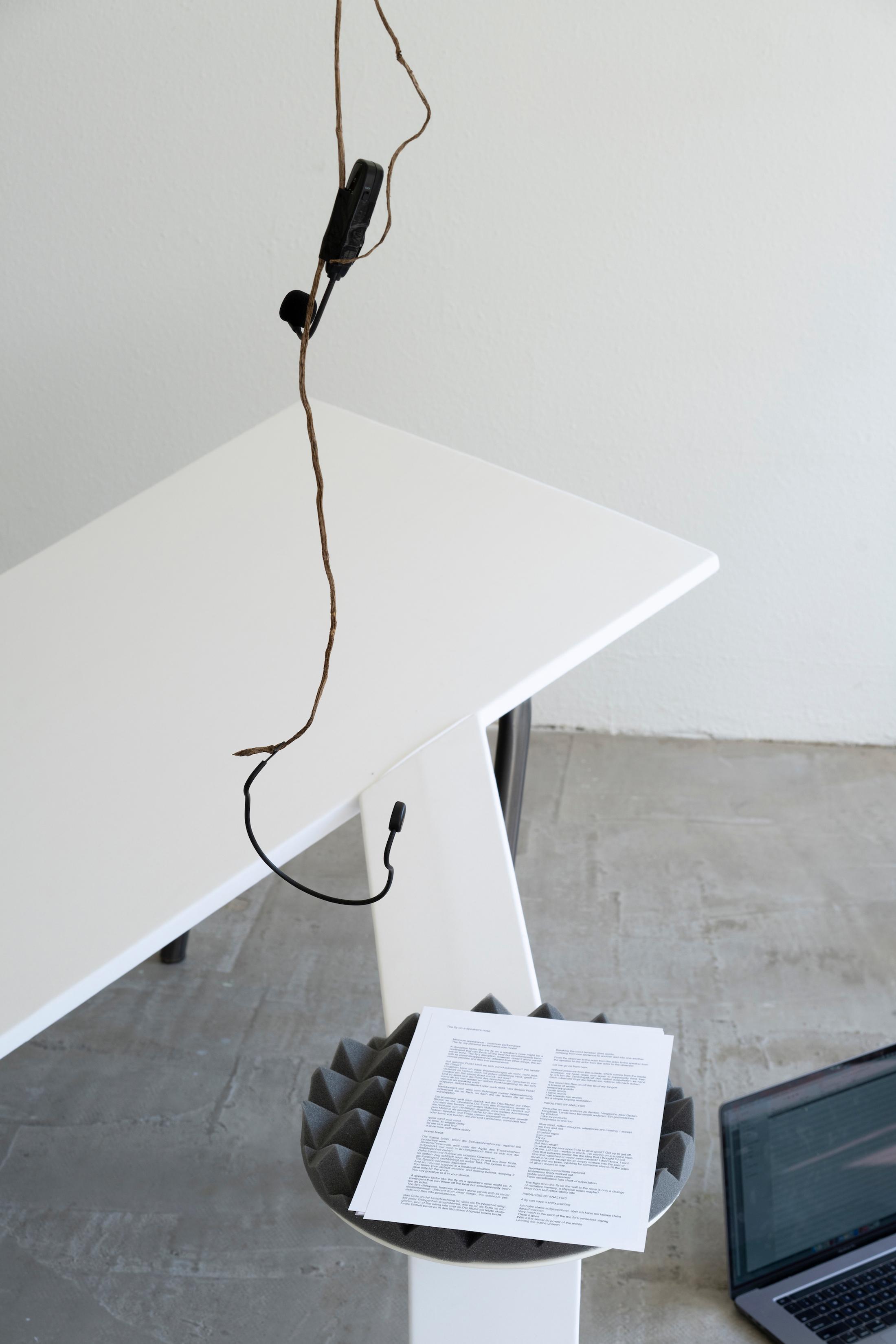 Exhibition View Mara Wohnhaas Solo Show «The fly on a speaker's nose; view on Mara Wohnhaas, The fly on a speaker's nose (Detail), 2023, Wooden board, fabric, acoustic, foam, shows, sand, root, headset microphone, text on paper, steel, nails, staples, 400 x 160 x 80 cm» at Hamlet, Zurich, 2023 / Photo: Claude Barrault / Courtesy: the artist and Hamlet