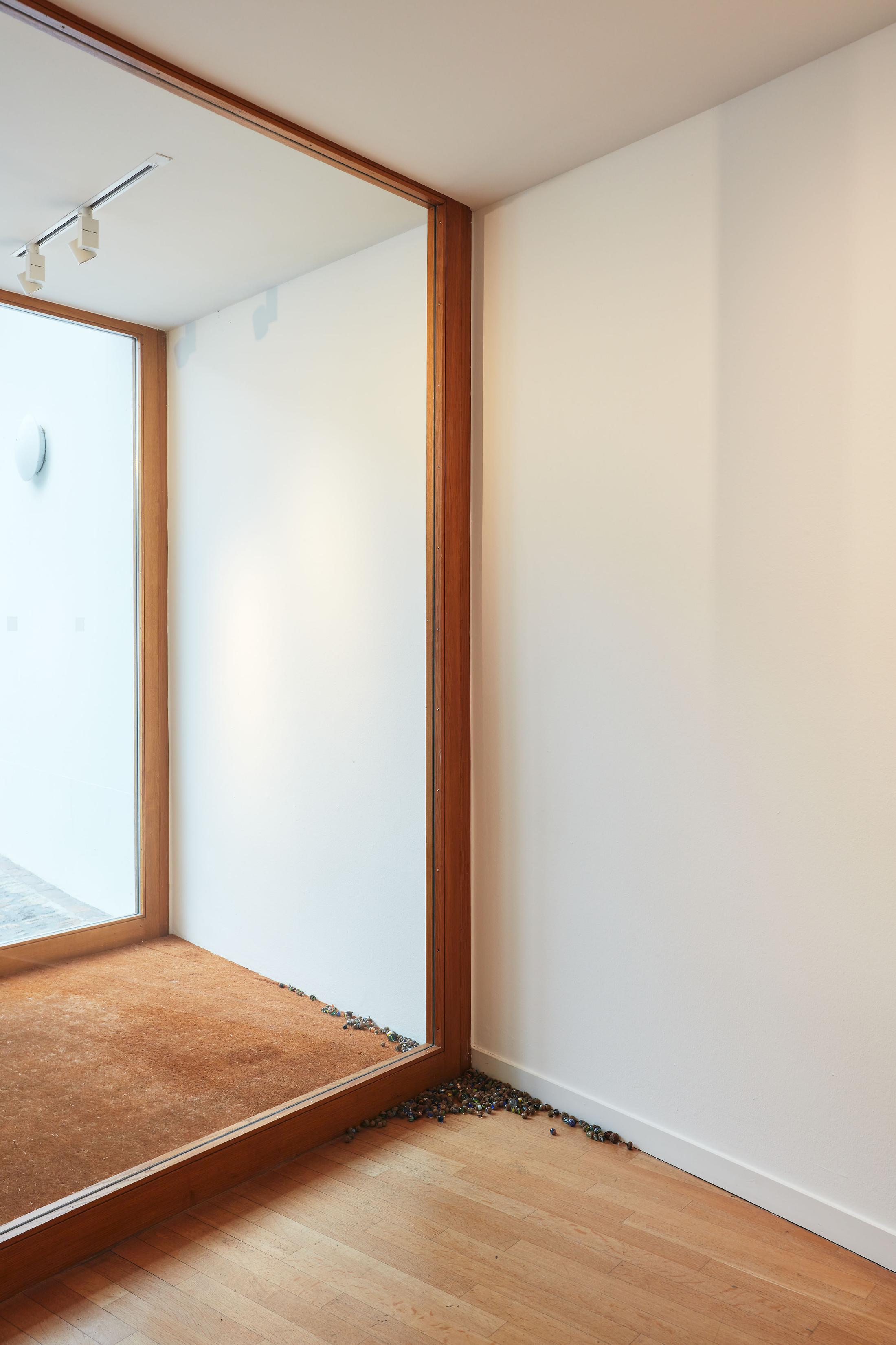 Exhibition View Groupshow «Motor; view on Aline Zeltner, untitled, marbles in acorn hats, variable dimensions, 2020» at Kunstraum Riehen, Riehen, Basel, 2020 / Photo: Moritz Schermbach / Courtesy: the artist