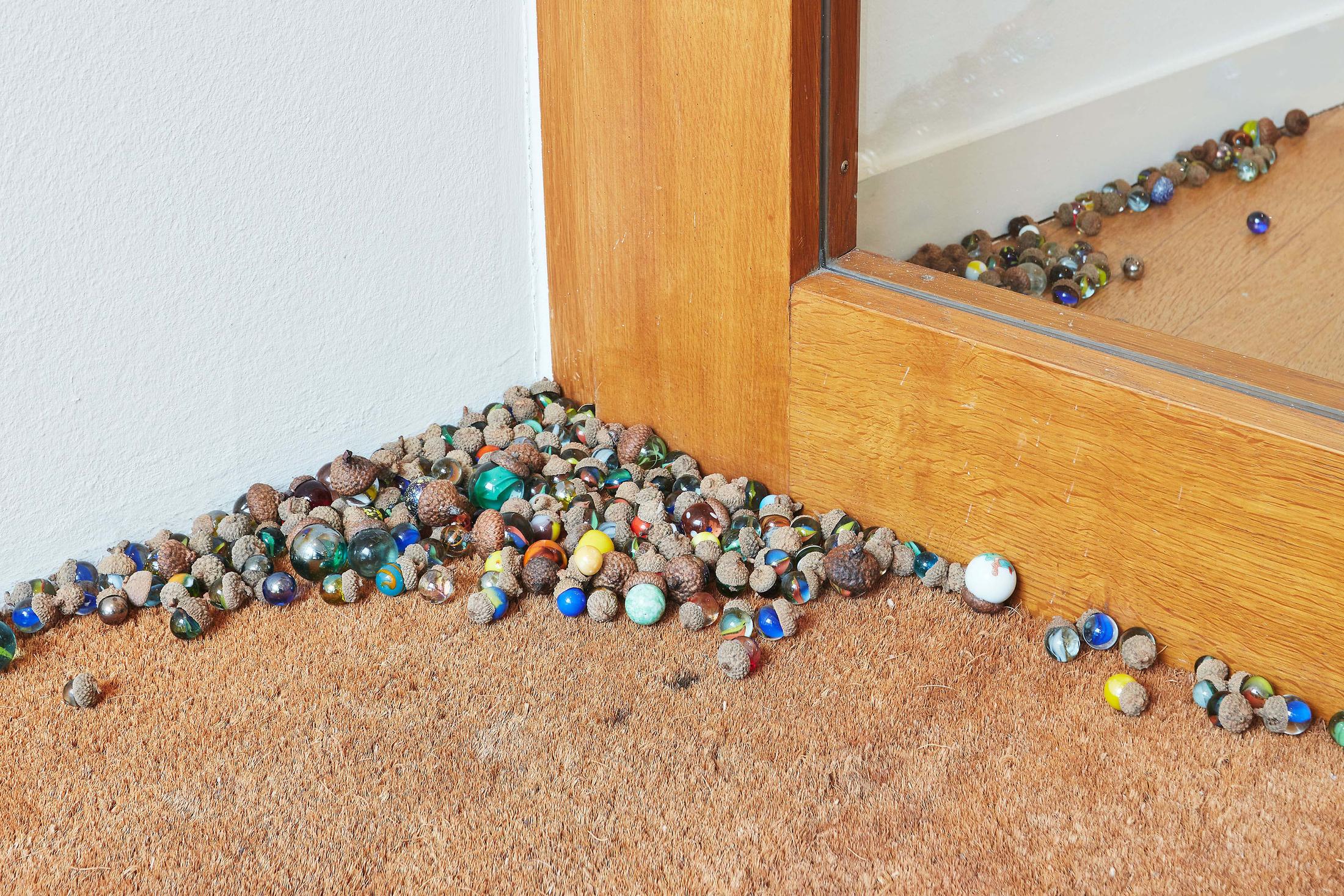Exhibition View Groupshow «Motor; view on Aline Zeltner, untitled, marbles in acorn hats, variable dimensions, 2020» at Kunstraum Riehen, Riehen, Basel, 2020 / Photo: Moritz Schermbach / Courtesy: the artist